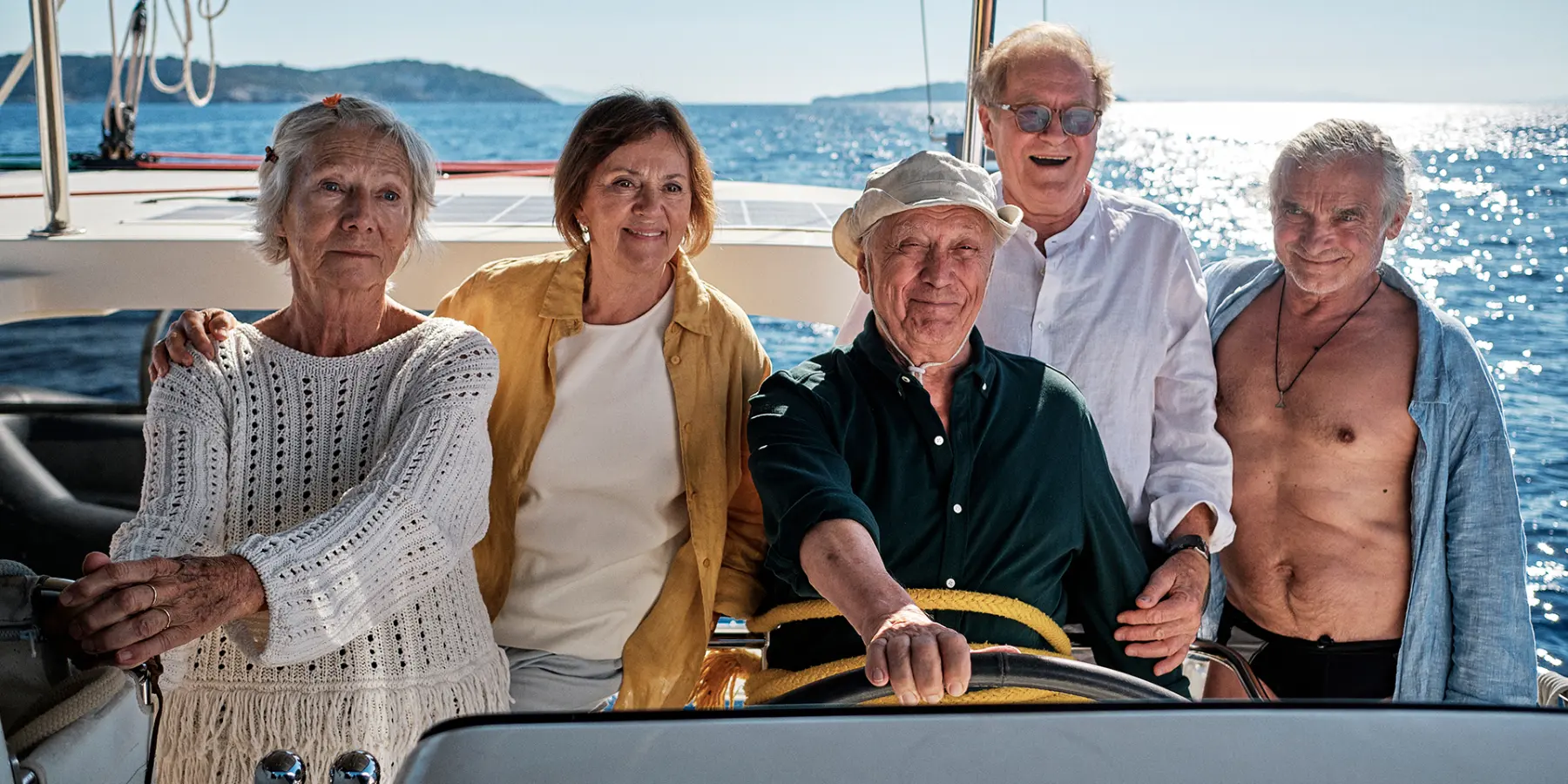What a Way to Go — five friends gathered at the helm of a boat at sea